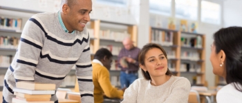 3 students looking at a computer