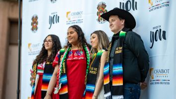 4 students standing in front of a CLEA backdrop