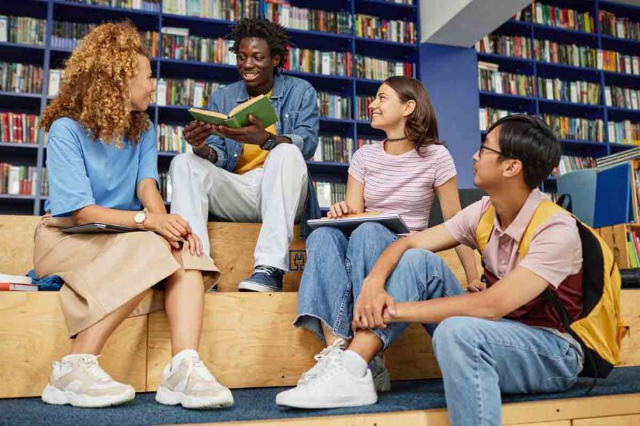 Teens reading books in library